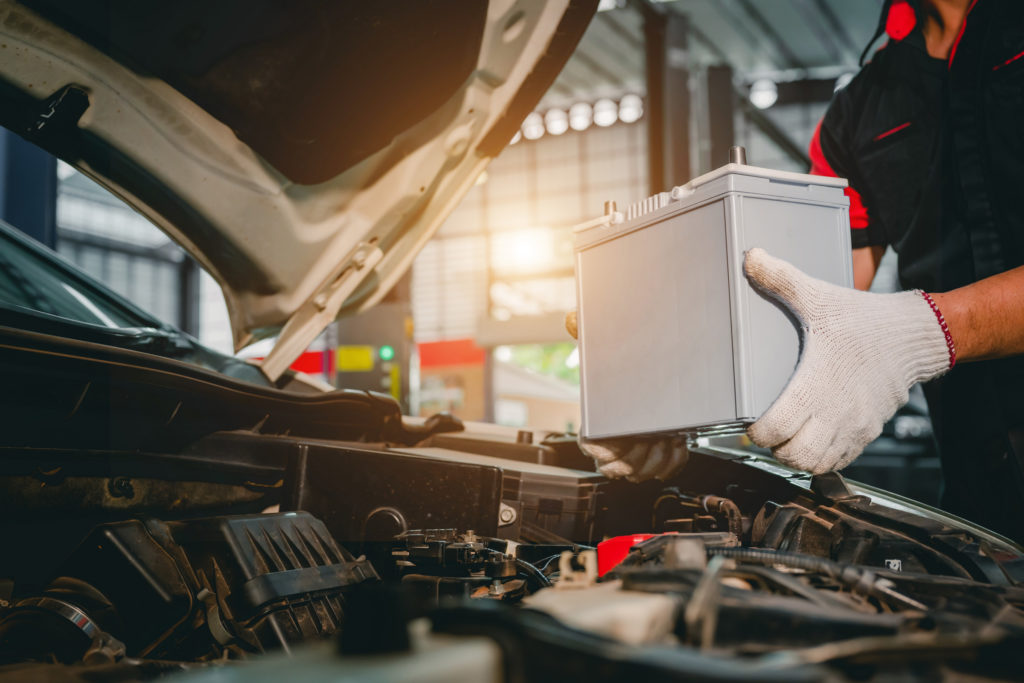 Mechanic replacing a car battery