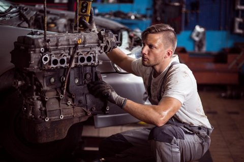 Mechanics checking vehicles in a garage